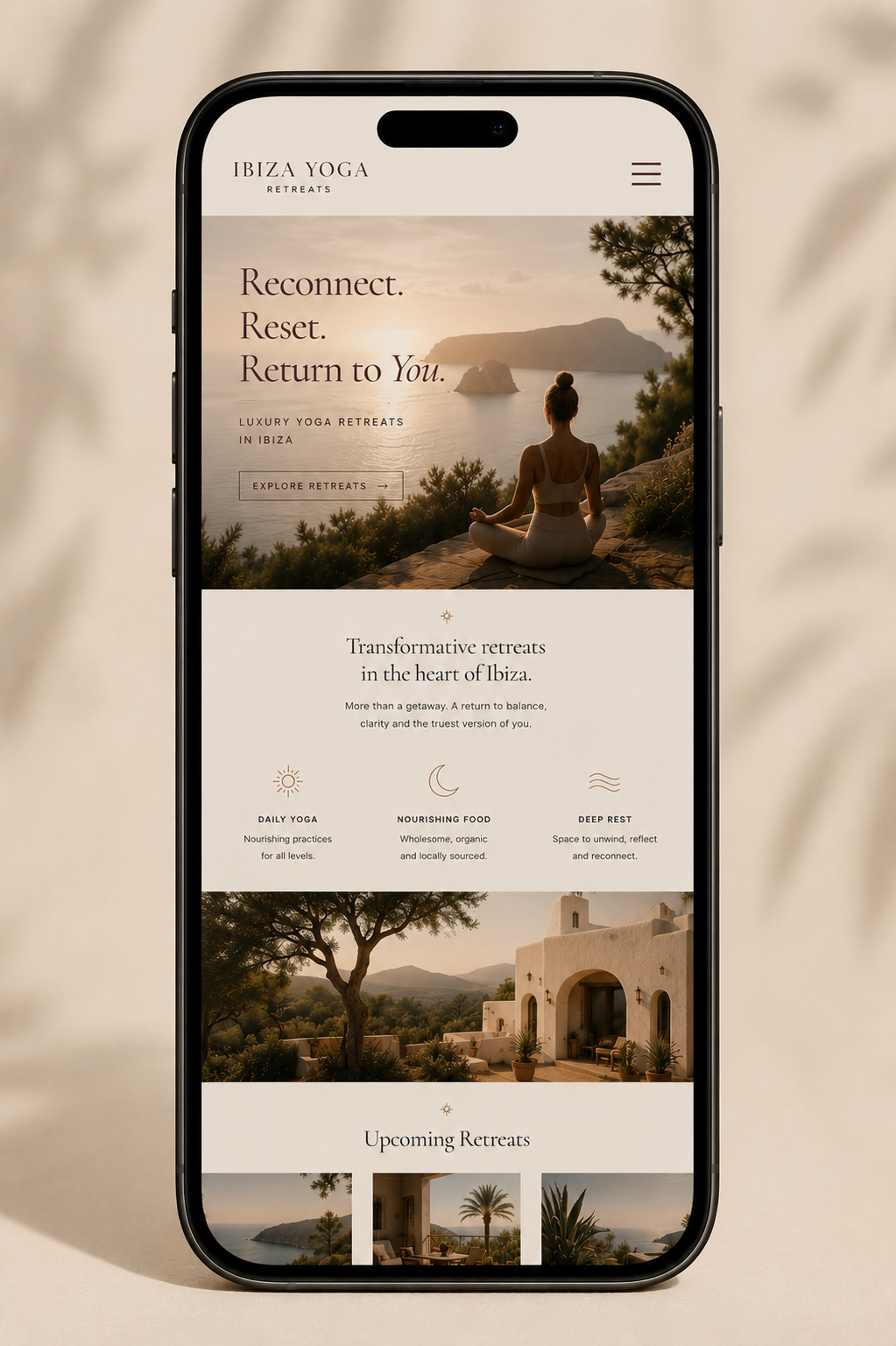 Luxury yoga website displayed on a mobile phone screen